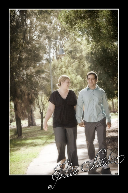 engaged couple walking in the park